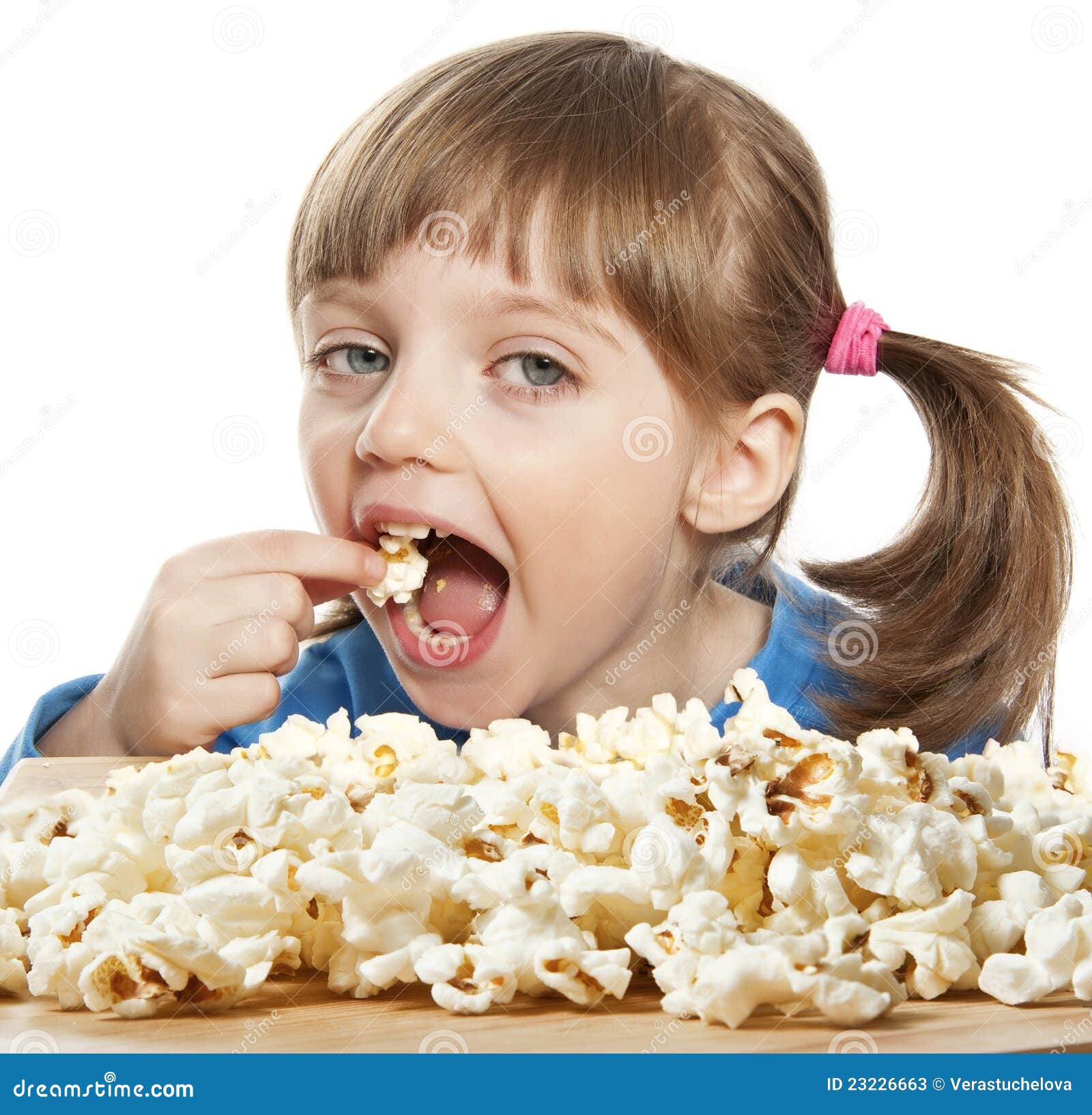 little-girl-eating-popcorn-23226663.jpg
